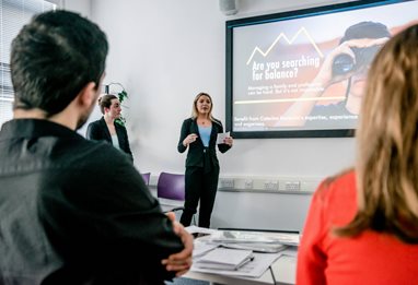 A woman in a suit giving a business presentation