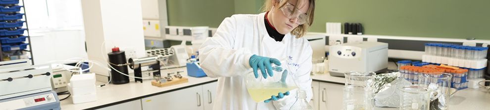 Meghan volunteering in a lab coat