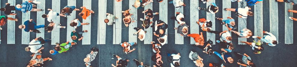 Aerial. People crowd on pedestrian crosswalk. Top view background. Toned image