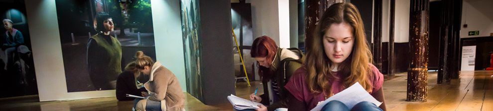 Students making notes in a photography gallery