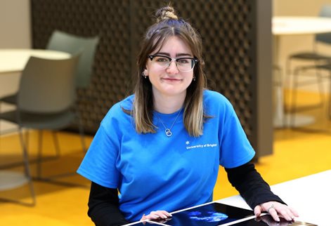 Student ambassador in a blue University of Brighton t-shirt