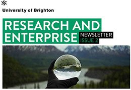 University of Brighton research and enterprise newsletter cover shows title and a hand holding a spherical lens up to a river landscape.