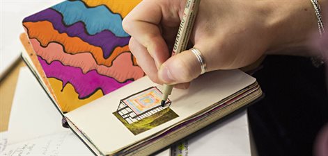 Drawing colourful shapes in a notebook