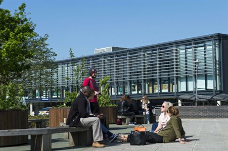 Students sitting outside at the Falmer campus
