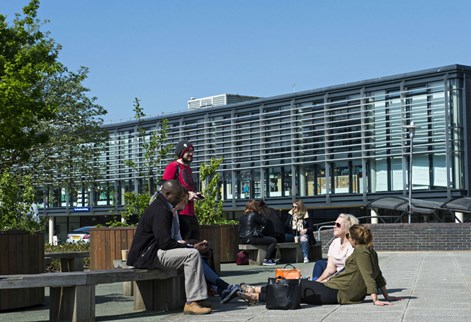 Group of students sitting outside on Falmer campus