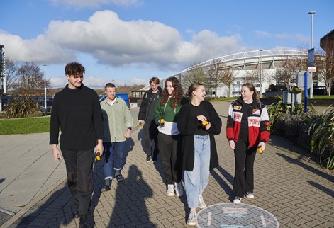 group of students walking through Falmer campus