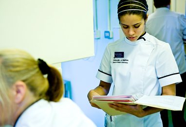 Podiatry student looking at patients notes with frown on her face