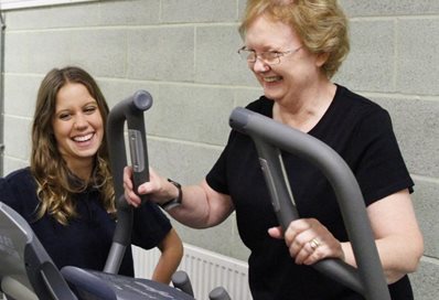 A mature woman on a treadmill in a sports lab