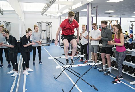 jumping hurdles during fitness testing