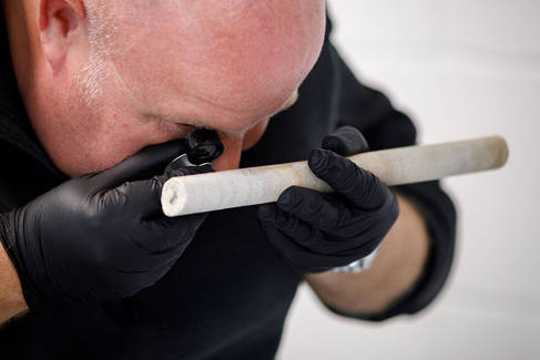 Professor Dave Nash analysing the sarsen core extracted from Stone 58 at Stonehenge. Photo by Sam Frost, English Heritage