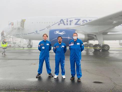 Three people in blue jumpsuits ready to board the weightless parabolic flight 
