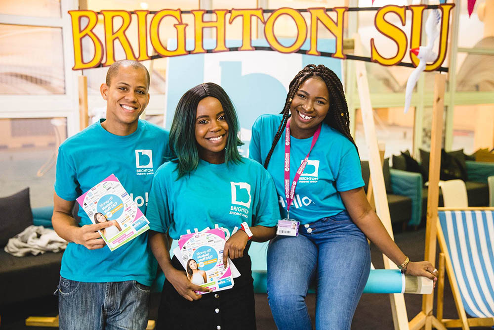 Three students wearing Brighton SU t-shirts