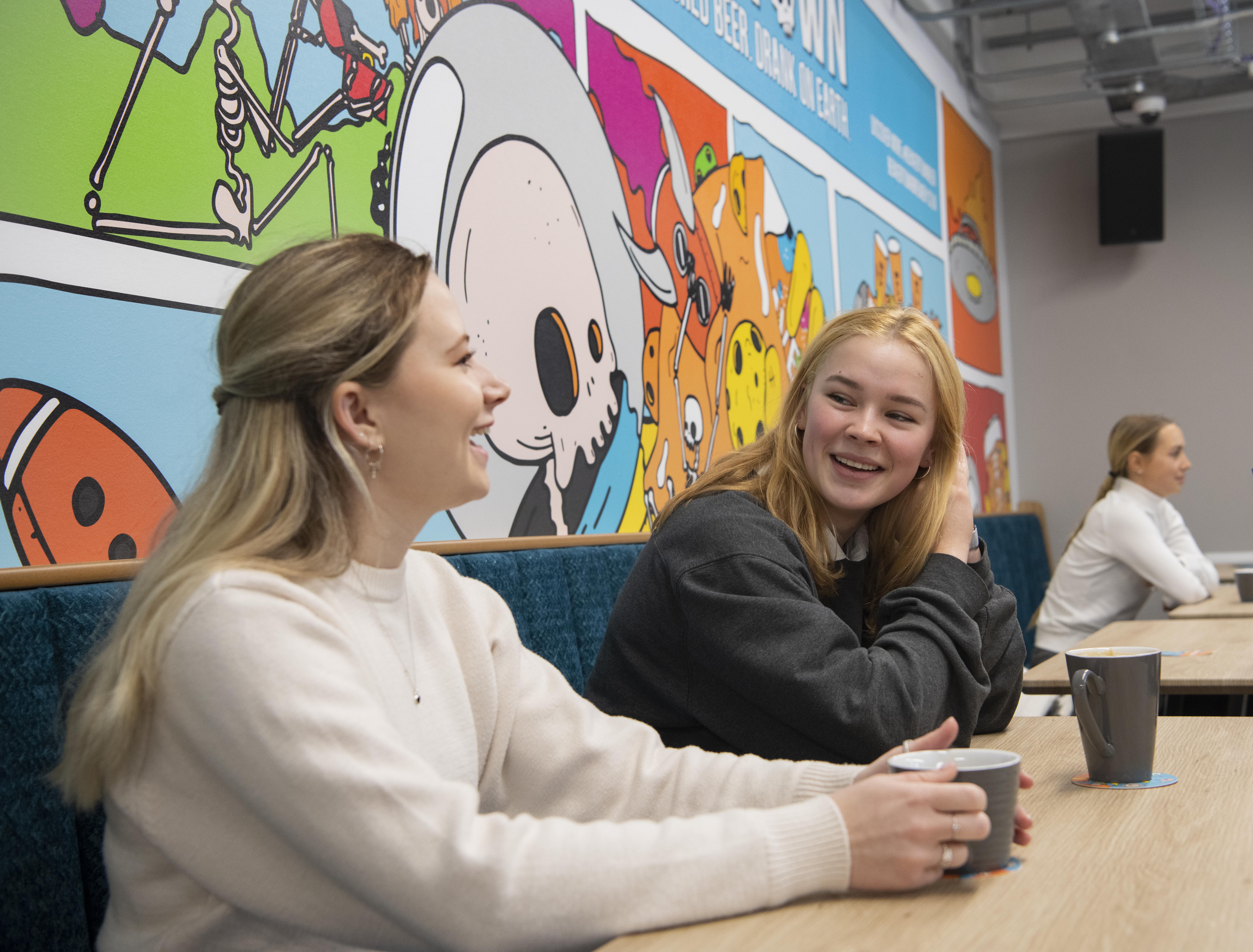 Two students having a coffee in the Students' Union Bar