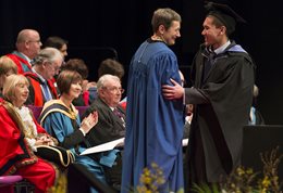 Debra Humphris shaking hands at graduation