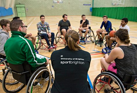 A circle of basketball players in wheelchairs