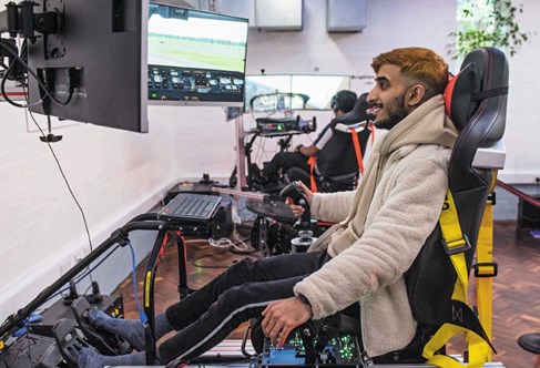 A student in a driving simulation