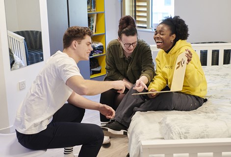 Three students laughing in Mithras halls of residence