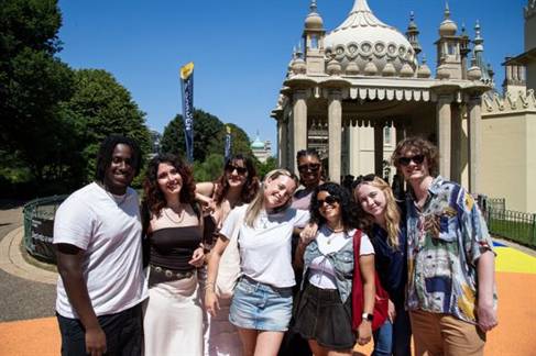A group of students outside Brighton Pavilion on a sunny day
