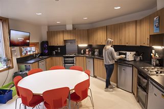A student cooking in a kitchen in Varley Park halls
