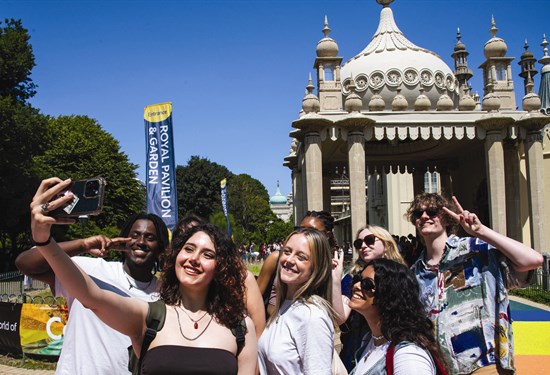 A group of students taking a selfie outside Brighton Pavillion