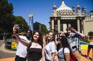 A group of students taking a selfie outside Brighton Pavillion