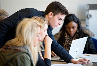 Business students looking at papers