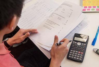 Student using calculator to work out mock questions