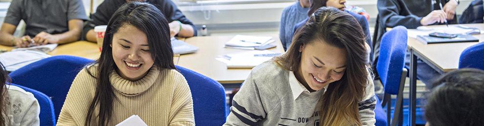 Smiling Business Management students in lecture