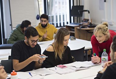 A group of students checking figures together
