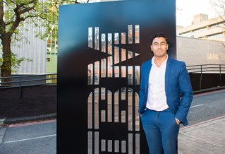 Student in front of the IBM sign