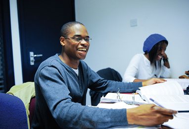 Business school students laughing in the seminar