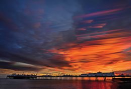 Brighton pier in very dramatic sunset