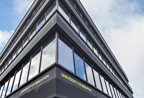 Steep perspective corner view of the black and smoked glass Edward Street building, University of Brighton