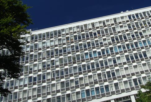 Angular view of the eight-storey Cockcroft building, white concrete with geometry of small windows