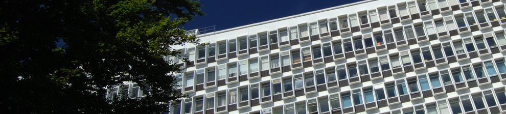 Angular view of the eight-storey Cockcroft building, white concrete with geometry of small windows
