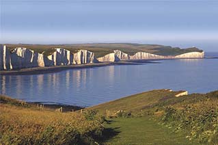 view of white cliffs and sea from grassy hill