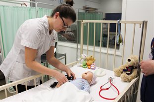 Apprentice Nurse caring for baby doll