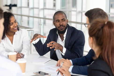 Five people having a discussion in a meeting