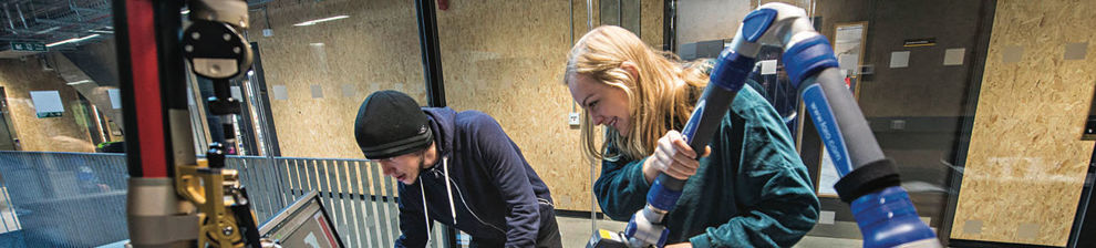 Engineering students working with machinery