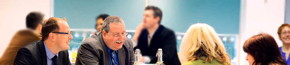 Group of business people sitting round a table