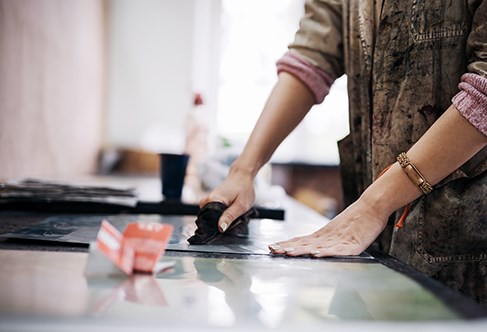 Person standing using printing tools