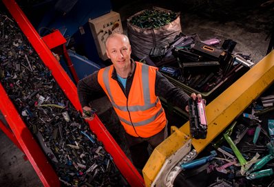 A man in a hi-viz vest working in a recycling plant