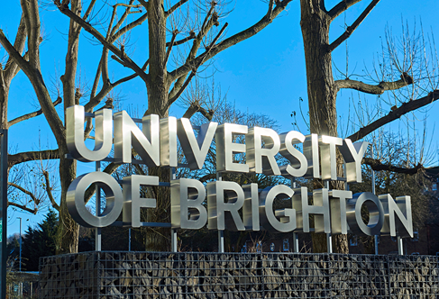 University of Brighton signage against blue winter sky