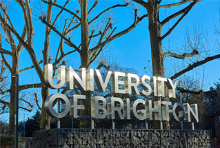 University of Brighton signage against blue winter sky