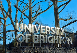 University of Brighton signage against blue winter sky
