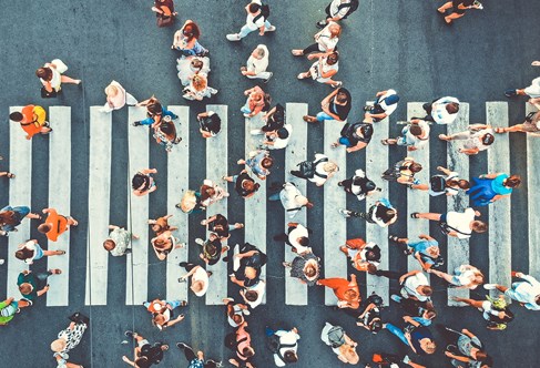 Aerial. People crowd on pedestrian crosswalk. Top view background. Toned image