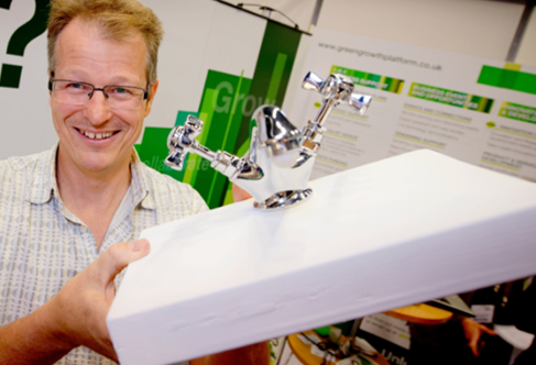 Nigel Bamford from Waterblade holding a sink with his tap