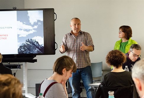 A presenter talking to a crowd