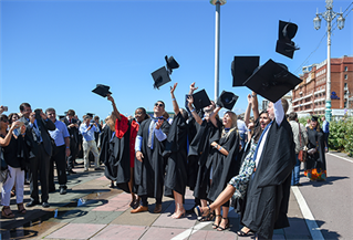 A group of graduates throwing their caps in the air