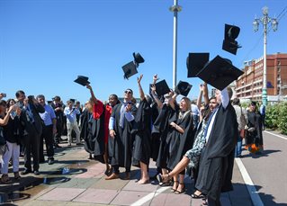 A group of graduates throwing their caps in the air
